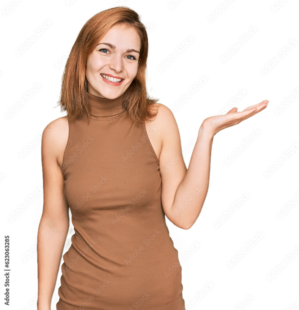 Poster Young caucasian woman wearing casual clothes smiling cheerful presenting and pointing with palm of hand looking at the camera.