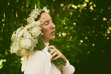 woman in white blouse with flower bouquet and headband VII