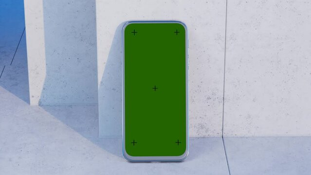 Camera movement towards the phone. Phone on a concrete table. Green chroma key with crosses on the phone screen. Template for the design of your site, application, interface.