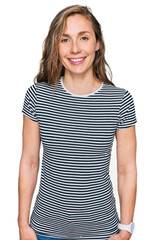 Fototapeta premium Young blonde woman wearing casual clothes with a happy and cool smile on face. lucky person.