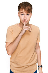 Young caucasian man wearing casual clothes asking to be quiet with finger on lips. silence and...