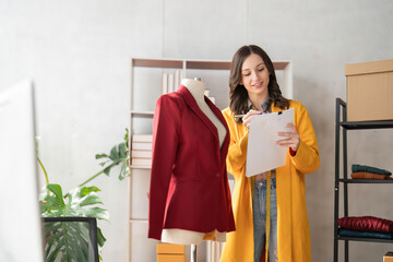 Female fashion designer are designing new trendy clothing collection. Fashion designer working in...