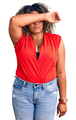 Young african american plus size woman wearing casual style with sleeveless shirt covering eyes with arm, looking serious and sad. sightless, hiding and rejection concept