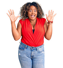 Young african american plus size woman wearing casual style with sleeveless shirt celebrating crazy and amazed for success with arms raised and open eyes screaming excited. winner concept