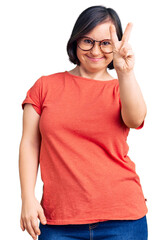 Brunette woman with down syndrome wearing casual clothes and glasses smiling with happy face...