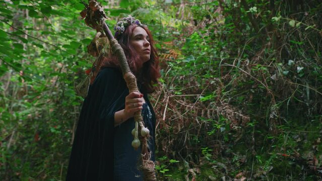young druid girl walking in a forest medium shot