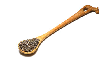 Chia seeds in wooden spoon. Healthy superfood rich in Omega 3 fatty acids. Dry healthy natural ingredient. Chia grains are falling