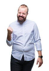 Young caucasian hipster man over isolated background very happy and excited doing winner gesture with arms raised, smiling and screaming for success. Celebration concept.