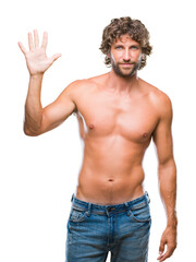 Fototapeta premium Handsome hispanic model man sexy and shirtless over isolated background showing and pointing up with fingers number five while smiling confident and happy.