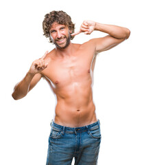 Fototapeta premium Handsome hispanic model man sexy and shirtless over isolated background smiling confident showing and pointing with fingers teeth and mouth. Health concept.