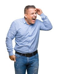 Fototapeta premium Middle age arab business man over isolated background very happy and smiling looking far away with hand over head. Searching concept.