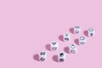 Story dice cubes on pastel pink backround.