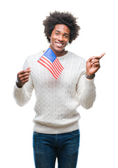 Afro american man flag of United States of America over isolated background very happy pointing...
