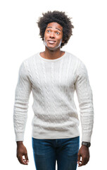 Afro american man over isolated background smiling looking side and staring away thinking.