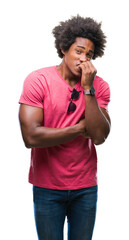 Afro american man over isolated background looking stressed and nervous with hands on mouth biting nails. Anxiety problem.