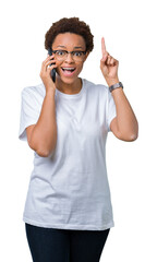 Young african american woman talking on the phone over isolated background surprised with an idea or question pointing finger with happy face, number one