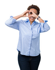 Young beautiful african american business woman over isolated background Doing heart shape with hand and fingers smiling looking through sign