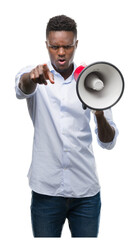 Young african american man holding megaphone pointing with finger to the camera and to you, hand...