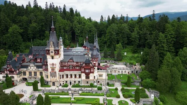Cinematic drone point of view of Peles Castle. Beautiful castle situated in Sinaia City , Romania, build for King Carol I. Famous holiday destinations in Romania. Drone going backward, ascending