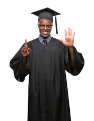 Young graduated african american man over isolated background showing and pointing up with fingers number six while smiling confident and happy.