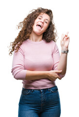 Beautiful brunette curly hair young girl wearing pink sweater over isolated background smiling with happy face winking at the camera doing victory sign. Number two.