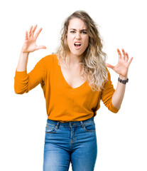 Fototapeta na wymiar Beautiful young blonde woman over isolated background crazy and mad shouting and yelling with aggressive expression and arms raised. Frustration concept.