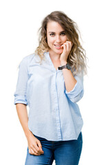 Beautiful young blonde business woman over isolated background looking stressed and nervous with hands on mouth biting nails. Anxiety problem.