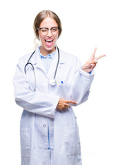 Beautiful young blonde doctor woman wearing medical uniform over isolated background smiling with happy face winking at the camera doing victory sign. Number two.