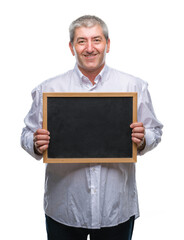 Handsome senior teacher man holding blackboard over isolated background with a happy face standing and smiling with a confident smile showing teeth