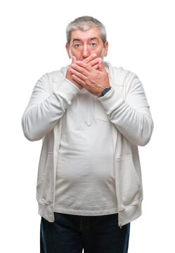 Handsome senior man wearing sport clothes over isolated background shocked covering mouth with hands for mistake. Secret concept.