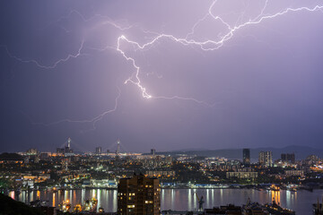 Thunderstorm with lightning over over cityscape.