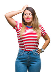 Fototapeta premium Young beautiful woman casual look over isolated background confuse and wonder about question. Uncertain with doubt, thinking with hand on head. Pensive concept.