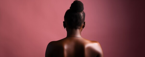 silhouette of a black woman infront of a pink wall, Standing Muscular Black Woman from Behind, Set against a Pink Background, Bathed in Natural Light and Accentuated by Natural Shadows