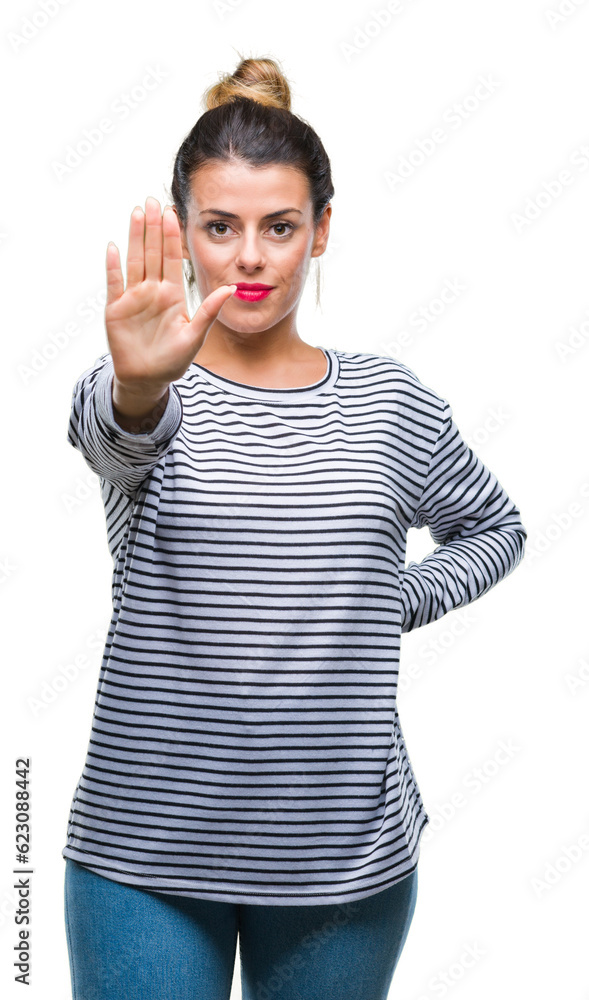 Sticker Young beautiful woman casual stripes sweater over isolated background doing stop sing with palm of the hand. Warning expression with negative and serious gesture on the face.