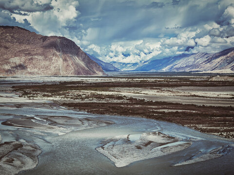 Vintage retro effect filtered hipster style image of Nubra valley and Nubra river in Himalayas. Ladakh, Jammu and Kashmir, India