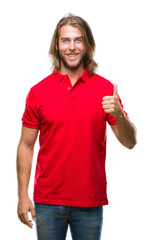 Young handsome man with long hair over isolated background doing happy thumbs up gesture with hand. Approving expression looking at the camera with showing success.