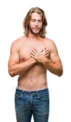 Young handsome shirtless man with long hair showing sexy body over isolated background smiling with hands on chest with closed eyes and grateful gesture on face. Health concept.