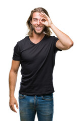 Young handsome man with long hair over isolated background doing ok gesture with hand smiling, eye looking through fingers with happy face.