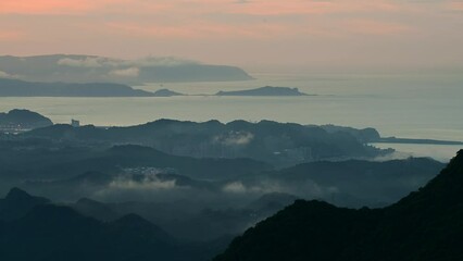 Shapes of floating clouds and mountain tops. View of the sea at sunset. Wufen Mountain in Pingxi was photographed from Buyanting Pavilion. Taiwan