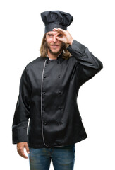 Young handsome cook man with long hair over isolated background doing ok gesture with hand smiling, eye looking through fingers with happy face.