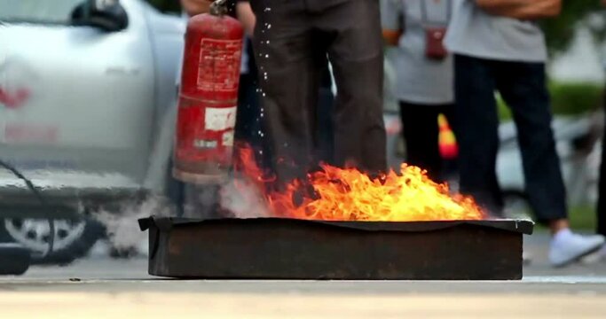 fireman Firefighters spraying water onto a burning pit Rescue trained in fire fighting extinguisher hazardous fires
