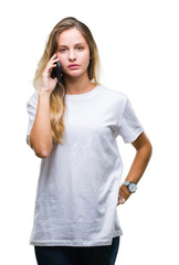 Young beautiful blonde woman calling using smartphone over isolated background with a confident...