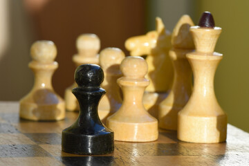 Game of chess. Old chess pieces on chessboard, close-up. The move of the black pieces.