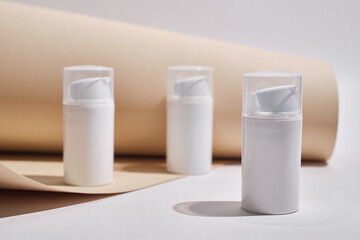 Container for cream, shampoo, toiletries, spa. Unbranded white plastic bottles. Bottle with a dispenser for cosmetic products. Skin care and beauty concept. Mockup style, copy space