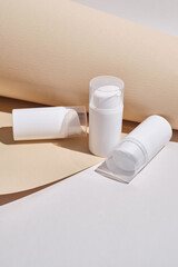 Container for cream, shampoo, toiletries, spa. Unbranded white plastic bottles. Bottle with a dispenser for cosmetic products. Skin care and beauty concept. Mockup style, copy space