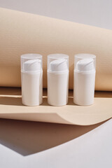 Container for cream, shampoo, toiletries, spa. Unbranded white plastic bottles. Bottle with a dispenser for cosmetic products. Skin care and beauty concept. Mockup style, copy space