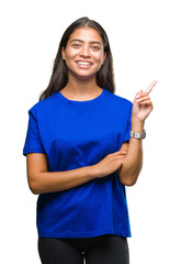 Young beautiful arab woman over isolated background with a big smile on face, pointing with hand and finger to the side looking at the camera.