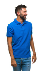 Obraz premium Adult hispanic man over isolated background looking away to side with smile on face, natural expression. Laughing confident.