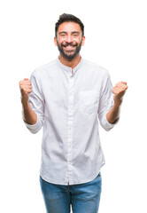 Adult hispanic man over isolated background celebrating surprised and amazed for success with arms raised and open eyes. Winner concept.