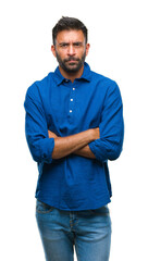 Adult hispanic man over isolated background skeptic and nervous, disapproving expression on face with crossed arms. Negative person.